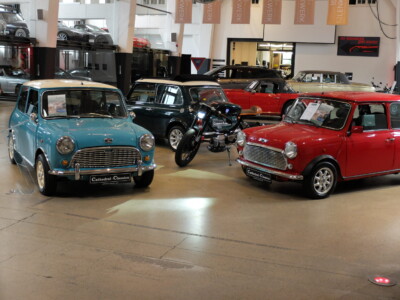 Metorbike between three Classic Minis